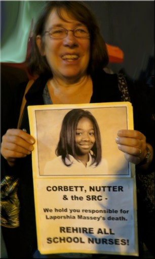 Betsey Piette carries poster Picture of Laporshia.